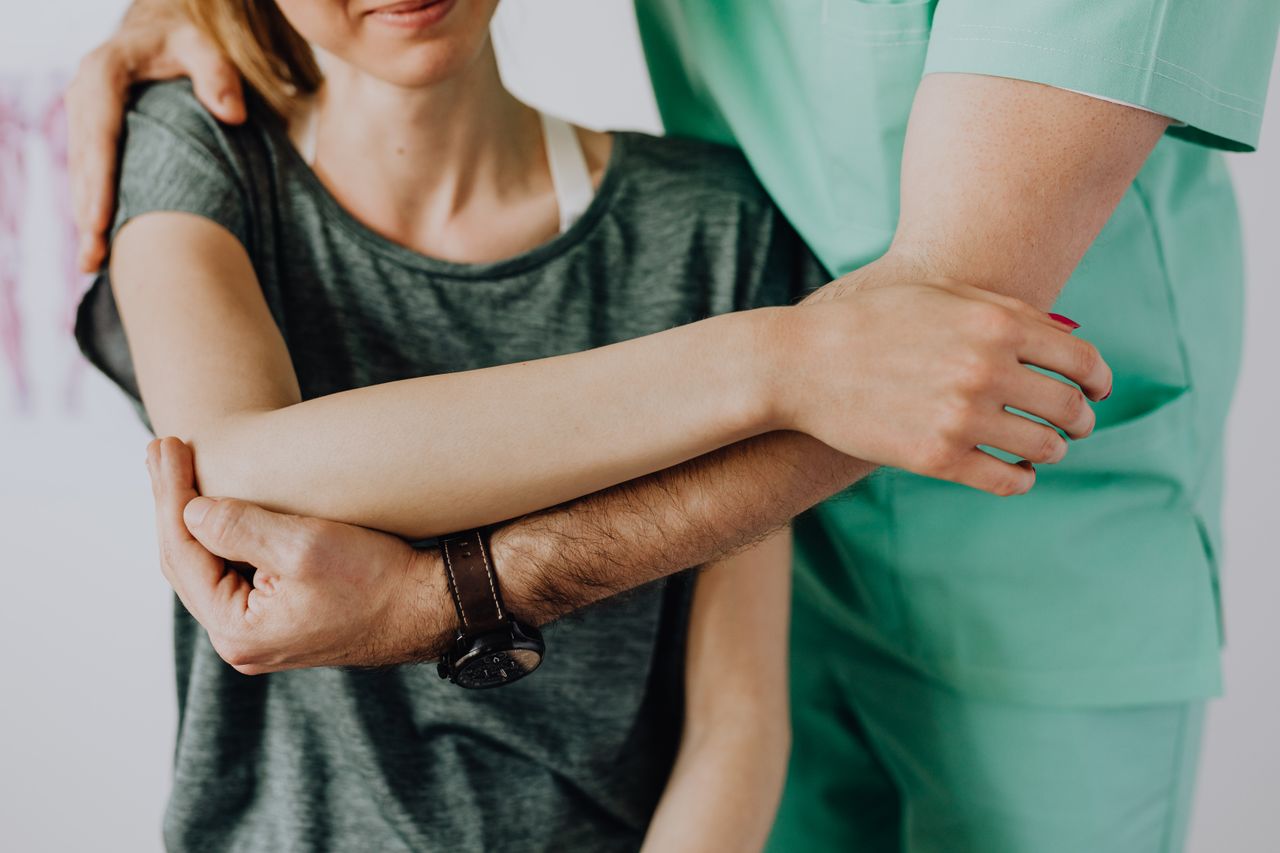 The Art of Drawing Readers In: Your attractive post title goes here Crop anonymous chiropractor in uniform and wristwatch examining shoulder of smiling faceless woman in casual clothes in doctor office in clinic